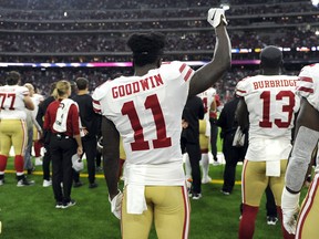 San Francisco 49ers wide receiver Marquise Goodwin holds up a fist during the playing of the national anthem before a pre-season game against the Houston Texans on Aug. 18.
