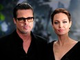 This file photo taken on May 8, 2014 shows actress Angelina Jolie (R) along with her husband actor Brad Pitt as they arrive for the premiere of the film "Maleficent" at Kensington Palace in London / AFP PHOTO / CARL COURTCARL COURT/AFP/Getty Images