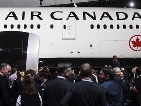 People view the newly revealed Air Canada Boeing 787-8 Dreamliner aircraft at a hangar at the Toronto Pearson International Airport in Mississauga, Ont., Thursday, February 9, 2017. Air Canada says 20,000 customers may have had their personal information "improperly accessed" due to a breach in its mobile app, prompting a lock-down on all 1.7 million accounts until consumers change their passwords.