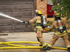 Calgary firefighters extinguish a house fire on Templeby Drive N.E on Saturday afternoon August 18, 2018. Gavin Young/Postmedia