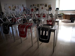 A vacant teacher's desk is pictured at the front of an empty classroom. File photo.