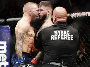 TJ Dillashaw celebrates after beating Cody Garbrandt, right, during a bantamweight title bout at UFC 217 Sunday, Nov. 5, 2017, in New York. (AP Photo/Frank Franklin II)