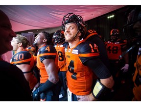 B.C. Lions quarterback Travis Lulay waits to be introduced before a CFL football game against the Winnipeg Blue Bombers in Vancouver on July 14.