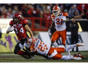 BC Lions' Anthony Thompson, right, tackles Calgary Stampeders' Ante Milanovic-Litre, during second half CFL football action in Calgary, Saturday, Aug. 4, 2018.THE CANADIAN PRESS/Jeff McIntosh ORG XMIT: JMC113