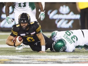 Saskatchewan Roughriders' Charleston Hughes sacks Hamilton Tiger-Cats quarterback Jeremiah Masoli during second half CFL football action in Hamilton, Ont., Thursday July 19, 2018.