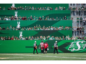 Calgary Stampeders defensive back Emanuel Davis (8) is escorted off the field after being ejected from the game during second half CFL action against the Saskatchewan Roughriders, in Regina on Sunday. The Saskatchewan Roughriders defeated the Calgary Stampeders 40-27.