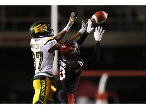 The Calgary Stampeders' Ciante Evans (0) knocks the ball away from the Edmonton Eskimos' Derel Walker late in the fourth quarter during CFL West Final football action in Calgary, Sunday, Nov. 19, 2017.THE CANADIAN PRESS/Todd Korol ORG XMIT: TAK118 ORG XMIT: POS1711191929544970
