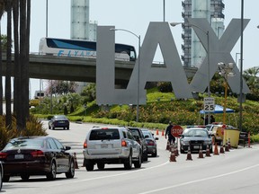 Cars stop at a checkpoint at the entrance of Los Angeles International Airport after security was increased following mutiple expolsions during the 117th Boston Marathon on April 15, 2013 in Los Angeles, California.