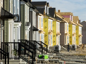 Construction on a row of housing continues in the Legacy area of south Calgary, Alta., on Wednesday, July 29, 2015. Growth was a hot topic arising from the latest civic census, released on Wednesday. Lyle Aspinall/Calgary Sun/Postmedia Network