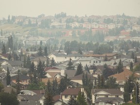 A smoke covered northwest Calgary is obscrured as seen from Country Hills Golf Course on Saturday, August 11, 2018. Jim Wells/Postmedia