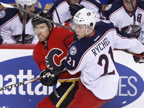 Columbus Blue Jackets' Kerby Rychel, right, battles with Calgary Flames' David Jones during first period NHL action in Calgary, Alta., Friday, Feb. 5, 2016. The Calgary Flames have acquired forward Kerby Rychel from the Montreal Canadiens in exchange for left-wing Hunter Shinkaruk. THE CANADIAN PRESS/Larry MacDougal ORG XMIT: CPT119