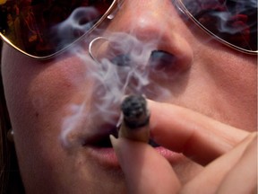 Thousands are expected to attend the 4-20 marijuana smoke-in at Vancouver's Sunset Beach Friday, and while the legalization goal of the annual Weed Day will soon be met, an event organizer says there is much more to protest. A woman smokes a joint during the annual 4-20 cannabis culture celebration at Sunset Beach in Vancouver, B.C., on Thursday, April 20, 2017. THE CANADIAN PRESS/Darryl Dyck ORG XMIT: CPT502