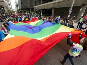 A giant pride flag is walked through the Calgary Pride Parade in the city's downtown core on Sept. 4, 2016.