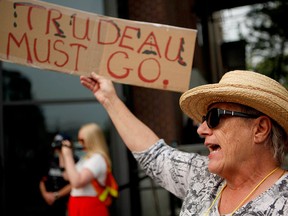 Protesters gather outside the Vancouver Island Conference Centre as ministers meet during day two of the Liberal cabinet retreat in Nanaimo, B.C., on Wednesday, Aug.22, 2018.