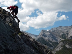A hiker scrambles over a challenging stretch on Heart Mountain, about 75 kilometres west of Calgary.