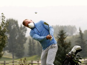 Alex Trenholm swings the clubs at Lynx Ridge Golf and Country Club as events throughout Calgary have been cancelled due to the heavy smoke on Sunday August 19, 2018. Darren Makowichuk/Postmedia