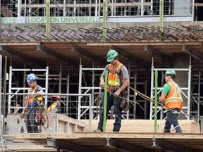 Construction workers on the job at the site for Montreal's CHUM super hospital in Montreal on July 2, 2013. Canada's national unemployment rate was 5.8 per cent in July. THE CANADIAN PRESS/Ryan Remiorz ORG XMIT: CPT104