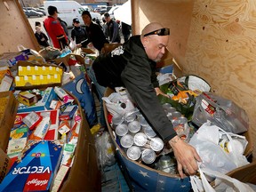 Volunteers work to fill a trailer full of donated food in Calgary, Alta on Sunday November 6, 2016. The food drive is too help fill the shelves at the Veterans Food Bank. Jim Wells//Postmedia