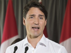 Prime Minister Justin Trudeau answers reporters questions during an event in Saint-Eustache, Que., on Aug. 16, 2018.