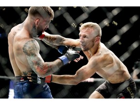 T.J. Dillashaw, right, hits Cody Garbrandt during their UFC title bantamweight mixed martial arts bout at UFC 227 in L.A. on Saturday.