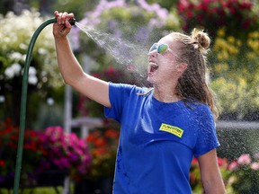 Breanne Schweitzer from Plantation Garden Centre takes a minute to cool down in Calgary on Tuesday Aug. 7, 2018.