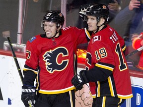 Calgary Flames Austin Czarnik celebrates his third goal on the Vancouver Canucks with teammate Matthew Tkachuk during their game against at the Scotiabank Saddledome in Calgary, Alta. on Saturday September 22, 2018. Leah Hennel/Postmedia