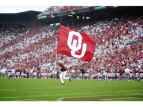 NORMAN, OK - SEPTEMBER 08: A member of the Oklahoma Sooners spirit squad celebrates a touchdown against the UCLA Bruins at Gaylord Family Oklahoma Memorial Stadium on September 8, 2018 in Norman, Oklahoma. The Sooners defeated the Bruins 49-21.