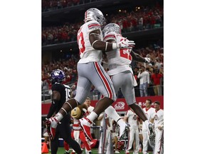 ARLINGTON, TX - SEPTEMBER 15:  Rashod Berry #13 and Parris Campbell #21 of the Ohio State Buckeyes celebrate a touchdown against the TCU Horned Frogs in the third quarter during The AdvoCare Showdown at AT&T Stadium on September 15, 2018 in Arlington, Texas.
