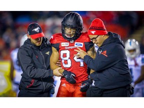 Calgary Stampeders Reggie Begelton is helped off the  field after being injured in a game against the Toronto Argonauts during CFL football in Calgary on Friday. Photo by Al Charest/Postmedia