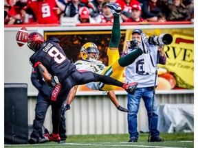 Calgary Stampeders' Emanuel Davis knocks the ball away from Vidal Hazelton of the Edmonton Eskimos during the Labour Day Classic in Calgary on Monday, September 3, 2018. Al Charest/Postmedia