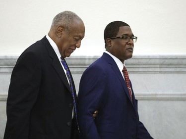 Bill Cosby is led from the courtroom during a break by his spokesman Andrew Wyatt at the Montgomery County Courthouse, during his sentencing hearing in Norristown, Pa., Monday, Sept. 24, 2018.