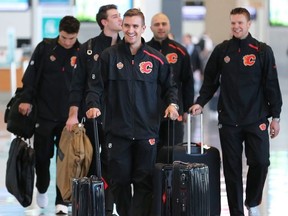 Calgary Flames forward Mikael Backlund, centre, leads teammates from left; Garnet Hathaway, Mark Jankowski, Mark Giordano and Brett Kulak as they walk through the Calgary International Airport before boarding a charter flight to Shenzhen, China on Tuesday September 11, 2018. The team will play two exhibition games against the Boston Bruins in China. Gavin Young/Postmedia