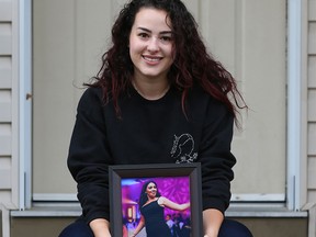 Racha El-Dib holds a photo of her sister of Nadia who was killed by an ex-boyfriend earlier this year.  She is is honouring her late sister's memory by helping survivors of domestic violence get their lives back from their abusers. Gavin Young/Postmedia