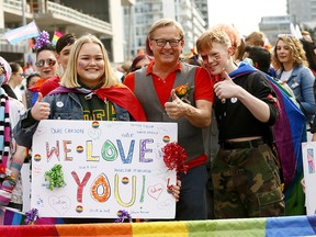 L-R, Students, Madison Jones and Clayton Poirier with the Minister of Education, David Eggen as thousands came out to watch and take part in Calgary's Pride Parade downtown in Calgary on Sunday September 2, 2018. Darren Makowichuk/Postmedia