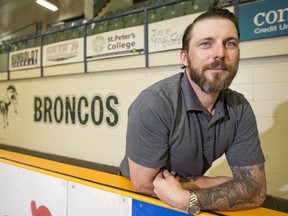 Humboldt Broncos new head coach, Nathan Oystrick, poses for a photograph on his team's bench.