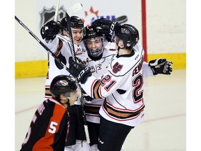 Tristen Nielsen, centre, celebrates  his goal with his teammates as the Calgary Hitmen took on the Medicine Hat Tigers at the Scotiabank Saddledome in Calgary, Alta., on February 10, 2017. Game tied 2-2 at the end of the first. Ryan McLeod/Postmedia Network