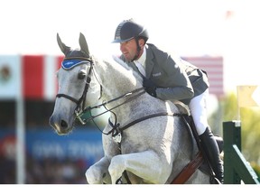 Philipp Weishaupt, from Germany, rides Solitaur in the Suncor Energy WInning Round at Spruce Meadows in Calgary on Saturday. He took first place. Photo by Jim Wells/Postmedia
