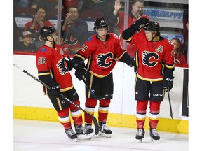 Flames Andrew Mangiapane (L) Dillon Dube (C) and Spencer Foo celebrate Dube's first-period goal during an NHL pre-season rookie game between the Edmonton Oilers and Calgary Flames in Calgary on Sunday, September 9, 2018. Jim Wells/Postmedia