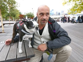 Emmanuel Gonzi poses with his service dog 'Smudge' during Recovery Day Calgary 2018 Sunday, September 9, 2018 held at Poppy Plaza on Memorial Drive NW in Calgary. Gonzi is a support worker at Oxford House and and has the dog to help him for emotional support after Gonzi lost his wife. Jim Wells/Postmedia