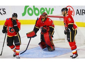 Calgary Flames T.J. Brodie, goaltender Mike Smith and Mark Giordano react after giving up a goal to C.J. Suess of the Winnipeg Jets during NHL pre-season hockey at the Scotiabank Saddledome in Calgary on Monday, September 24, 2018. Al Charest/Postmedia