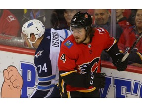 Calgary Flames Rasmus Andersson battles against Matt Ustaski of the Winnipeg Jets   during NHL pre-season hockey at the Scotiabank Saddledome in Calgary on Monday, September 24, 2018. Al Charest/Postmedia