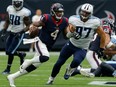 Texans QB Deshaun Watson (4) rushes with the ball as Karl Klug (97) of the Titans pursues during NFL action in Houston on Oct. 1, 2017.