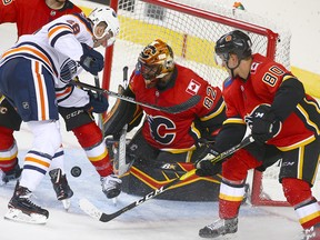 Flames Tyler Parsons minds the net duirng a goal mouth scramble during an NHL pre-season rookie game between the Edmonton Oilers and Calgary Flames in Calgary on Sunday, Sept. 9, 2018.