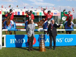 Team Germany, winners of the Nations' Cup, celebrate with Darryl White, BMO Financial Group CEO (front left) and German Chef D'Equipe Peter Hofmann during the Masters at Spruce Meadows in Calgary on Saturday, Sept. 8, 2018.