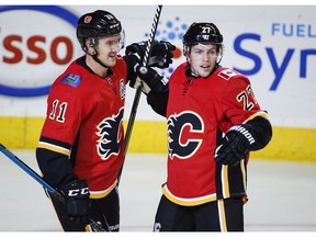 Calgary Flames' Austin Czarnik, right, celebrates his goal with Mikael Backlund, of Sweden, during preseason NHL hockey action against the Vancouver Canucks in Calgary, Saturday, Sept. 22, 2018.THE CANADIAN PRESS/Jeff McIntosh ORG XMIT: JMC103