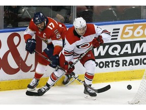 Then-Carolina Hurricanes centre Derek Ryan (7) and Florida Panthers centre Derek MacKenzie (17) battle for the puck in the third period of an NHL hockey game, Monday, April 2, 2018, in Sunrise, Fla. The Calgary Flames tapped into the Carolina Hurricanes pipeline again, signing centre Derek Ryan to a three-year contract on opening day of unrestricted free agency Sunday.