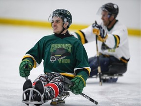 Humboldt Broncos bus crash survivor Ryan Straschnitzki, left, plays in a fund raising sledge hockey game in Calgary, Alta., Saturday, Sept. 15, 2018.THE CANADIAN PRESS/Jeff McIntosh ORG XMIT: JMC101