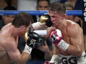 Canelo Alvarez, left, of Mexico, lands a punch on WBC/WBA middleweight champion Gennady Golovkin, of Khazakstan, during their title boxing fight at T-Mobile Arena in Las Vegas, Saturday, Sept. 15, 2018. Alvarez took Glolovkin's WBC/WBA titles by majority decision. (Steve Marcus/Las Vegas Sun via AP) ORG XMIT: NVLVS635