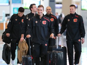 Calgary Flames forward Mikael Backlund, centre, leads teammates from left; Garnet Hathaway, Mark Jankowski, Mark Giordano and Brett Kulak as they walk through the Calgary International Airport before boarding a charter flight to Shenzhen, China on Tuesday September 11, 2018. The team will play two exhibition games against the Boston Bruins in China. Gavin Young/Postmedia