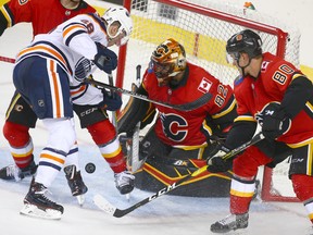 Flames Tyler Parsons minds the net duirng a goal mouth scramble during an NHL pre-season rookie game between the Edmonton Oilers and Calgary Flames in Calgary on Sunday, September 9, 2018. Jim Wells/Postmedia